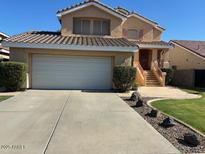 Two-story home with a two-car garage, well-manicured lawn, and traditional desert landscaping at 970 W Leah Ln, Gilbert, AZ 85233