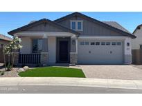 Charming single-story home featuring a two-car garage and well-manicured front yard with synthetic grass at 9963 W Verde Ln, Avondale, AZ 85392