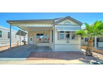 Charming manufactured home with covered parking, desert landscaping and delightful curb appeal at 111 S Greenfield Rd # 244, Mesa, AZ 85206