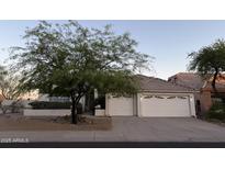 Charming single-story home with a well-maintained front yard and three-car garage at 12955 E Sahuaro Dr, Scottsdale, AZ 85259