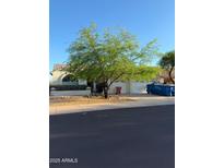 Charming single-story home with a two-car garage and mature desert landscaping at 12955 E Sahuaro Dr, Scottsdale, AZ 85259