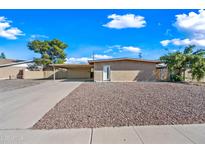 Tan brick home with a carport and desert landscaping at 1307 E Broadmor Dr, Tempe, AZ 85282