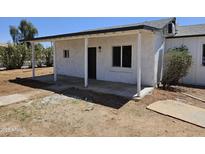 Charming home exterior with a covered porch, enhancing curb appeal and offering a welcoming entrance at 15445 N Verde St, Surprise, AZ 85378