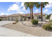 Beautiful single-story home with a tile roof, desert landscaping, and a spacious three-car garage at 15501 W Camino Real Way, Surprise, AZ 85374
