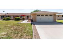 Charming single-story home featuring a two-car garage, well-maintained landscaping, and inviting curb appeal at 15614 N Lakeforest Dr, Sun City, AZ 85351