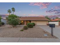 Charming single-story home with desert landscaping, palm trees, and a two-car garage at 15849 N 46Th Pl, Phoenix, AZ 85032