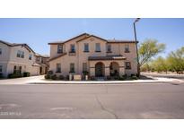 Charming two-story townhome with neutral stucco exterior and well-maintained landscaping at 16425 W Latham St, Goodyear, AZ 85338