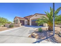 Charming single-story home featuring a three-car garage and desert landscaping at 189 N Rainbow Way, Casa Grande, AZ 85194