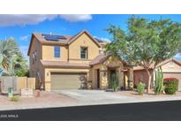 Two-story home with a two-car garage, solar panels, and a well-maintained front yard at 19321 N Tara Lane Ln, Maricopa, AZ 85138