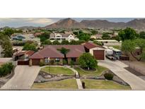 Expansive single-story home featuring mature trees, lush landscaping and mountain views at 21131 E Excelsior Ave, Queen Creek, AZ 85142