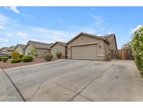 Charming single-story home featuring a two-car garage and well-manicured front yard at 2148 W Angelo Way, San Tan Valley, AZ 85144