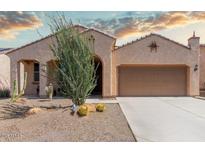 Charming single-story home featuring desert landscaping and a welcoming covered porch at 27418 W Mohawk Ln, Buckeye, AZ 85396