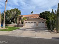 Lovely home featuring a large two-car garage, desert landscaping, and a red tile roof at 2955 E Hermosa Vista Dr, Mesa, AZ 85213