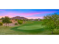 Lush golf course with manicured green, trees, and scenic mountain views at sunset in this community at 3277 E Meadowview Dr, Gilbert, AZ 85298