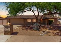 Charming brick home featuring a well-manicured front yard and two-car garage at 3536 W Cholla St, Phoenix, AZ 85029