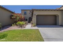 Charming two-story home with a well-manicured lawn, a beautiful tree, and a two-car garage at 4700 S Fulton Ranch Blvd # 62, Chandler, AZ 85248