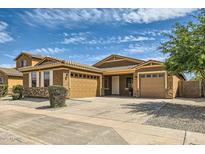 Charming single-Gathering home featuring a three-car garage, neutral paint, and well-maintained landscaping at 6815 W Carter Rd, Laveen, AZ 85339