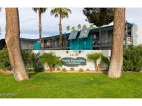 Charming condo complex with well-manicured lawn and distinctive turquoise accents at 6936 E 4Th St # 5, Scottsdale, AZ 85251