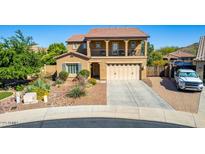 Two-story home featuring desert landscaping, balcony, and a two-car garage at 7039 W Katharine Way, Peoria, AZ 85383