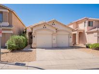 Charming single-story home with a three-car garage and well-maintained desert landscaping in front at 7227 E Kramer St, Mesa, AZ 85207
