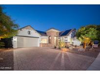 Beautiful single-Gathering home showcasing a brick driveway, desert landscaping, and a two-car garage at 7590 W Firebird Dr, Glendale, AZ 85308