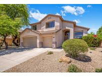 Charming two-story home featuring a well-manicured front yard, desert landscaping, and a three-car garage at 7758 E Nestling Way, Scottsdale, AZ 85255