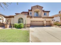 Stunning two-story home with a three-car garage, manicured lawn and a charming balcony with wrought iron details at 795 W Verbena Ln, Litchfield Park, AZ 85340