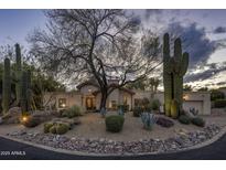Charming desert home featuring well-manicured landscaping and traditional architecture, creating curb appeal at 8255 E Vista De Valle --, Scottsdale, AZ 85255
