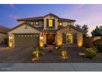 Charming two-story home with a stone accent wall, a manicured front yard, and a two-car garage at 831 E Tonto Pl, Chandler, AZ 85249