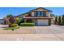 Beautiful two-story home featuring manicured landscaping and an attached garage at 8419 E Stella Ln, Scottsdale, AZ 85250