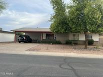 Charming single-story home with a covered carport and low-maintenance rock landscaping at 892 W Dublin St, Chandler, AZ 85225