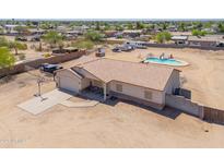 Charming single-Gathering home featuring a pool, spacious driveway with basketball hoop, and well-maintained landscaping at 9713 E El Paso St, Mesa, AZ 85207