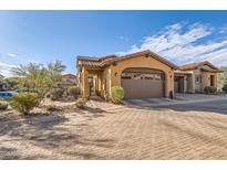 Charming single-Gathering home features a two-car garage, terra cotta roof, and desert landscaping at 17874 N 93Rd Way, Scottsdale, AZ 85255