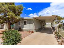 Well-maintained home with a covered parking area and appealing landscaping under a partly cloudy sky at 201 S Greenfield Rd # 331, Mesa, AZ 85206