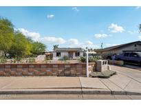 Charming single-story home featuring a well-maintained front yard and a 'For Sale' sign at 2118 E Oak St, Phoenix, AZ 85006