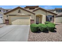 Charming single-story home showcasing a well-manicured front yard, attached garage, and inviting entrance at 23862 W Chambers St, Buckeye, AZ 85326