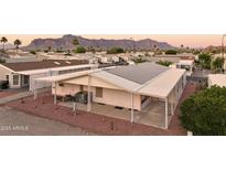 This home features solar panels, covered parking, and desert landscaping with views of the mountains at 2400 E Baseline Ave # 71, Apache Junction, AZ 85119