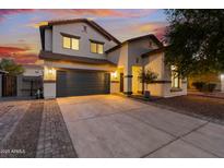 Inviting two-story home featuring desert landscaping, a spacious driveway, and a convenient two-car garage at 2533 W Novak Way, Phoenix, AZ 85041