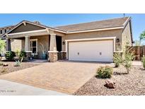 Beautiful single-story home featuring neutral tones, a brick driveway, and a two-car garage at 29403 N 119Th Ln, Peoria, AZ 85383