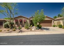 Charming single-story home featuring desert landscaping and a two-car garage at 3336 W Morse Dr, Anthem, AZ 85086