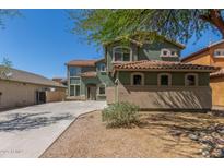 Beautiful two-story home with a red tile roof, an extended driveway, and a well-manicured yard at 45080 W Buckhorn Trl, Maricopa, AZ 85139