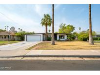 Charming single-story home with a well-maintained front yard and a two-car garage in a sunny neighborhood at 501 E Alameda Dr, Tempe, AZ 85282