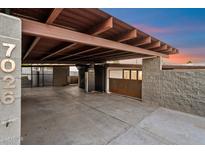 Spacious carport featuring a secure gated entrance, modern concrete, and a sturdy steel structure at 7026 E Pasadena Ave, Paradise Valley, AZ 85253