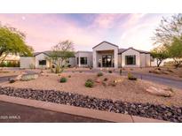 Stunning modern home with desert landscaping, circular driveway, and elegant front entrance at 9301 E Via Montoya --, Scottsdale, AZ 85255