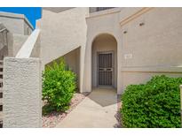 Charming condo exterior featuring a welcoming entrance and lush landscaping at 9455 E Raintree Dr # 1025, Scottsdale, AZ 85260