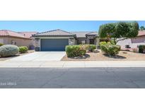 Charming single-story home featuring a well-maintained front yard, desert landscaping, and a two-car garage at 16527 W Blackhawk Ct, Surprise, AZ 85374