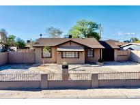 Charming single-story home featuring a well-maintained yard and classic architectural details at 1914 W Colter St, Phoenix, AZ 85015