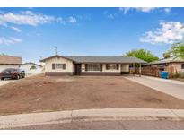 Charming single-story home featuring a covered carport and a neutral color scheme with brown accents at 2022 E Mulberry Dr, Phoenix, AZ 85016