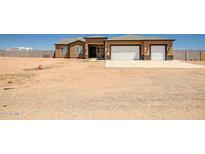 Single Gathering home featuring a two car garage and desert landscaping at 23408 W Barwick Dr, Wittmann, AZ 85361