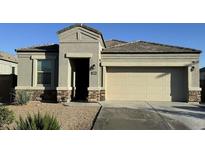 Charming single-story home with a two-car garage and well-maintained front yard at 30935 W Mulberry Dr, Buckeye, AZ 85396
